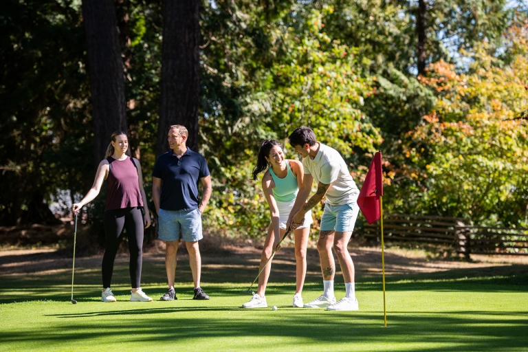 Four young adults on a golfing green